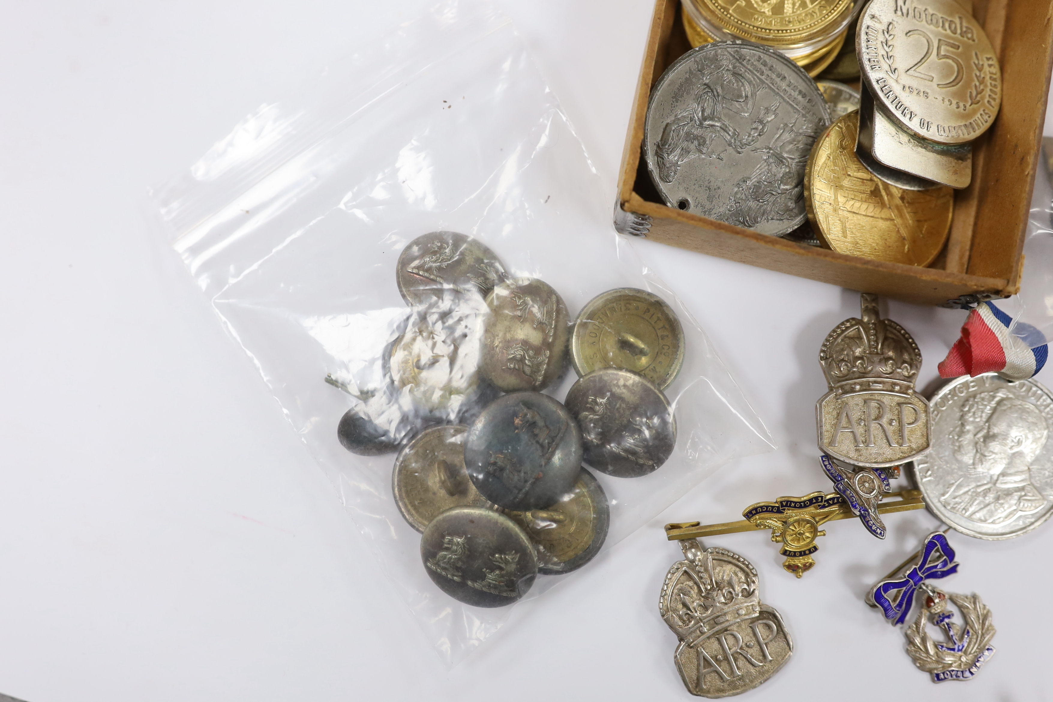 A collection of medals, cap badges, commemorative coins etc. including; a cased RMS Lusitania medal, Royal Artillery sweetheart brooches, a miniature WWII medal group of three stars; the 1939-45 Star, the Atlantic Star a